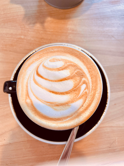 Latte Art in einer Tasse Kaffee – Moment der Ruhe auf einer Geschäftsreise